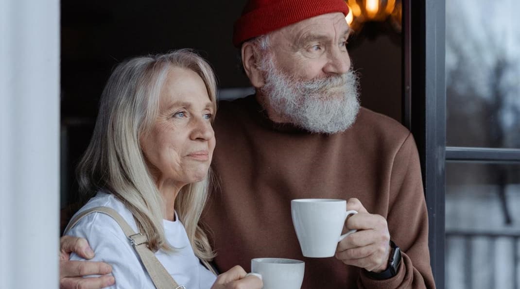 A couple drinking herbal tea instead of coffee after learning how to stop feeling tired