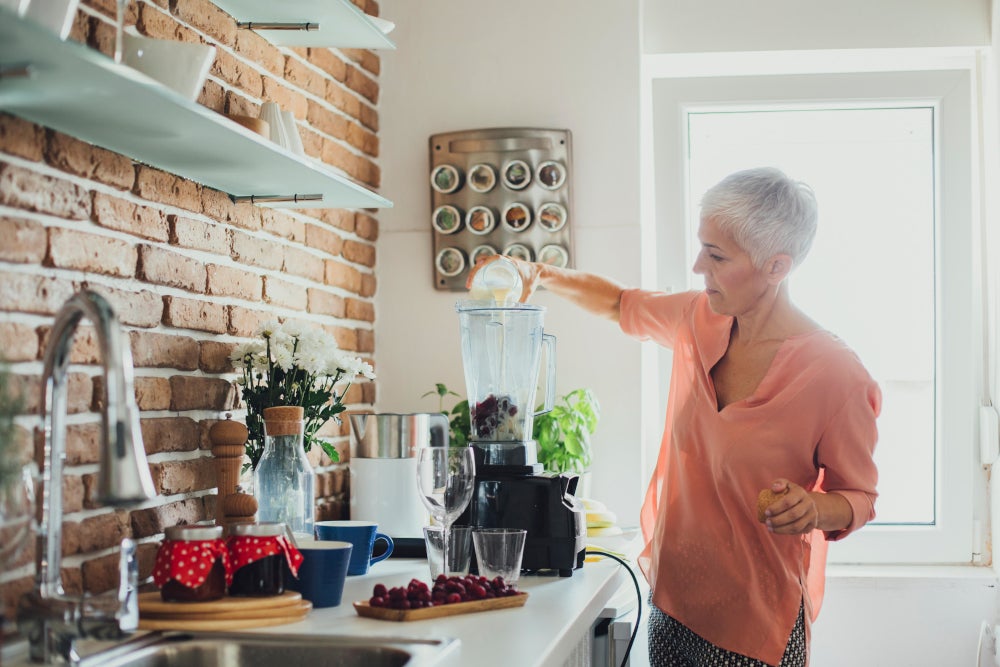 Woman making smoothie Thumbnail